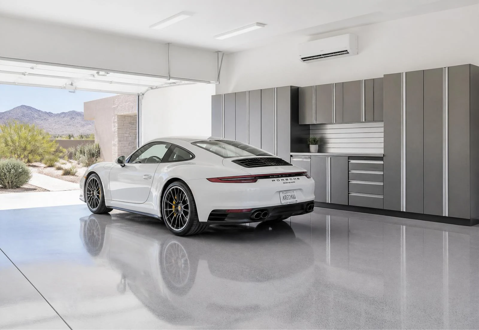 Clean modern Arizona garage with epoxy floors and a ductless indoor wall unit